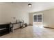 Bonus room featuring tile flooring and a sliding glass door to the back yard at 9865 Penny Ln, Las Vegas, NV 89178
