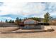 Two-story home with stone accents, a second story balcony, and desert landscaping at 9865 Penny Ln, Las Vegas, NV 89178