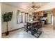 Eat in kitchen has tile floors and is decorated with a plant and unique light fixtures at 9865 Penny Ln, Las Vegas, NV 89178