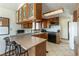 Traditional kitchen features wood cabinets, a breakfast bar, a black range, and light countertops at 9865 Penny Ln, Las Vegas, NV 89178