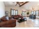 Spacious living room features tile floors, a wood beam ceiling, and lots of natural light at 9865 Penny Ln, Las Vegas, NV 89178