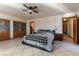 Main bedroom with ceiling fan, tile flooring, built-in wardrobe, and ensuite bath at 9865 Penny Ln, Las Vegas, NV 89178