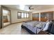 Spacious main bedroom with large windows, built-in wardrobe, and tile flooring at 9865 Penny Ln, Las Vegas, NV 89178