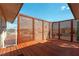 A spacious outdoor deck with wood flooring and lattice-style privacy panels at 9865 Penny Ln, Las Vegas, NV 89178