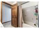 A shower and bathtub with white tile surround and a shower curtain at 9865 Penny Ln, Las Vegas, NV 89178
