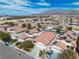 Aerial view of a planned community showcases rooftops, landscaping, street, and solar panels at 1016 Echo Beach Ave, North Las Vegas, NV 89086
