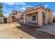 View of the home's backyard area with shed, covered patio, and tan stucco exterior at 1016 Echo Beach Ave, North Las Vegas, NV 89086