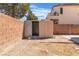 Backyard features a small storage shed with double doors and brick accents at 1016 Echo Beach Ave, North Las Vegas, NV 89086