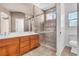 Bathroom featuring double sinks, a glass-enclosed shower, and tile accents at 1016 Echo Beach Ave, North Las Vegas, NV 89086