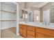 Bathroom features dual sinks, and a spacious walk-in closet with built-in shelving at 1016 Echo Beach Ave, North Las Vegas, NV 89086