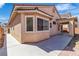 Exterior view of home showcasing stucco, covered patio, and manicured back yard at 1016 Echo Beach Ave, North Las Vegas, NV 89086