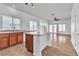 Open kitchen with an island, wooden cabinetry, and abundant natural light at 1016 Echo Beach Ave, North Las Vegas, NV 89086