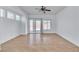 Open living space featuring tile floors, a ceiling fan, and sliding glass doors at 1016 Echo Beach Ave, North Las Vegas, NV 89086