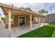 Backyard with a covered patio, artificial grass, and sliding glass doors at 10452 Niagara Falls Ln, Las Vegas, NV 89144