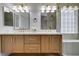 Bright bathroom with double sinks, stylish wood vanity, and a glass-enclosed shower at 10452 Niagara Falls Ln, Las Vegas, NV 89144
