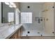 Elegant bathroom featuring a glass shower with gold fixtures and a double sink vanity at 10452 Niagara Falls Ln, Las Vegas, NV 89144