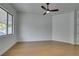 Minimalist bedroom with light wood floors, a modern ceiling fan, and bright natural light at 10452 Niagara Falls Ln, Las Vegas, NV 89144