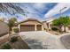 Two-car garage with desert landscaping and mature trees at 10452 Niagara Falls Ln, Las Vegas, NV 89144
