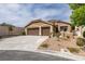 Charming home featuring a two-car garage and desert landscaping at 10452 Niagara Falls Ln, Las Vegas, NV 89144
