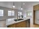 Kitchen island with marble countertop, stainless steel appliances, and wood accents at 10452 Niagara Falls Ln, Las Vegas, NV 89144