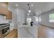 Kitchen island featuring modern faucet, marble counters, and stainless steel range at 10452 Niagara Falls Ln, Las Vegas, NV 89144