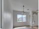 Bright living room features a window with a neighborhood view and modern chandelier at 10452 Niagara Falls Ln, Las Vegas, NV 89144
