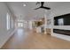 Spacious open floor plan with hardwood floors features a view of the kitchen and a bright entry way at 10452 Niagara Falls Ln, Las Vegas, NV 89144