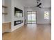 Bright living room featuring a fireplace, modern ceiling fan, and access to the backyard at 10452 Niagara Falls Ln, Las Vegas, NV 89144