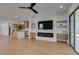 Open floor plan with hardwood floors seamlessly connects the living room, kitchen, and backyard at 10452 Niagara Falls Ln, Las Vegas, NV 89144
