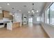Spacious living room with modern light fixtures and sliding glass doors to backyard at 10452 Niagara Falls Ln, Las Vegas, NV 89144