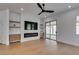 Bright living room features hardwood floors, built-in shelves, a modern fireplace, and backyard access at 10452 Niagara Falls Ln, Las Vegas, NV 89144