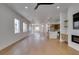 Expansive open floor plan with hardwood floors and bright lighting leads to the entryway and kitchen at 10452 Niagara Falls Ln, Las Vegas, NV 89144