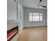 Bright bedroom features hardwood floors, a large window, and fireplace at 10452 Niagara Falls Ln, Las Vegas, NV 89144