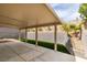 Covered patio featuring modern design, artificial turf, and landscaped retaining wall at 10452 Niagara Falls Ln, Las Vegas, NV 89144