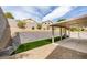 Spacious covered patio with retaining wall, landscaped hillside, and artificial turf at 10452 Niagara Falls Ln, Las Vegas, NV 89144