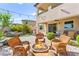 Beautiful backyard features a fire pit, comfortable seating, and lush landscaping at 12245 Olivetta Ct, Las Vegas, NV 89138
