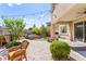 Serene backyard with a spa, waterfall feature, and comfortable wicker chairs at 12245 Olivetta Ct, Las Vegas, NV 89138