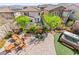 Aerial view of backyard featuring outdoor seating, hot tub, and lush landscaping at 12245 Olivetta Ct, Las Vegas, NV 89138