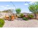 Charming backyard with wicker seating, a water feature, and beautiful landscaping at 12245 Olivetta Ct, Las Vegas, NV 89138