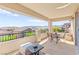 A covered outdoor balcony with seating, featuring beautiful views of the surrounding desert landscape at 12245 Olivetta Ct, Las Vegas, NV 89138