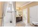 Well-lit bathroom featuring a vanity, decorative mirror, shower with a curtain, and a toilet at 12245 Olivetta Ct, Las Vegas, NV 89138