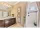 Well-lit bathroom showcasing dark wood cabinets, a shower with a curtain, and elegant fixtures at 12245 Olivetta Ct, Las Vegas, NV 89138