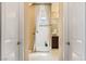 Bright bathroom featuring neutral tile, shower with glass door, and dark wooden vanity at 12245 Olivetta Ct, Las Vegas, NV 89138