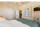 Bedroom with a neutral color scheme, featuring a sliding closet and an ensuite bathroom at 12245 Olivetta Ct, Las Vegas, NV 89138