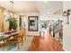 Open-concept dining area featuring a glass-top table, hardwood floors, and views of the kitchen and living spaces at 12245 Olivetta Ct, Las Vegas, NV 89138