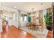 Inviting dining room showcasing hardwood floors, a glass table, and ample natural light streaming through multiple windows at 12245 Olivetta Ct, Las Vegas, NV 89138