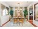 Charming dining area highlighted by wood chairs and plenty of natural light, ideal for entertaining and Gathering meals at 12245 Olivetta Ct, Las Vegas, NV 89138
