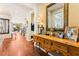 Inviting foyer with hardwood flooring, an elegant console table, and a staircase leading to the upper level at 12245 Olivetta Ct, Las Vegas, NV 89138