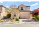 Charming two-story home featuring a neutral color palette, low maintenance landscaping, and a two-car garage at 12245 Olivetta Ct, Las Vegas, NV 89138