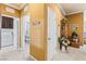 Hallway view with doorways to the laundry room and bedroom, decorated with furniture and accessories at 12245 Olivetta Ct, Las Vegas, NV 89138